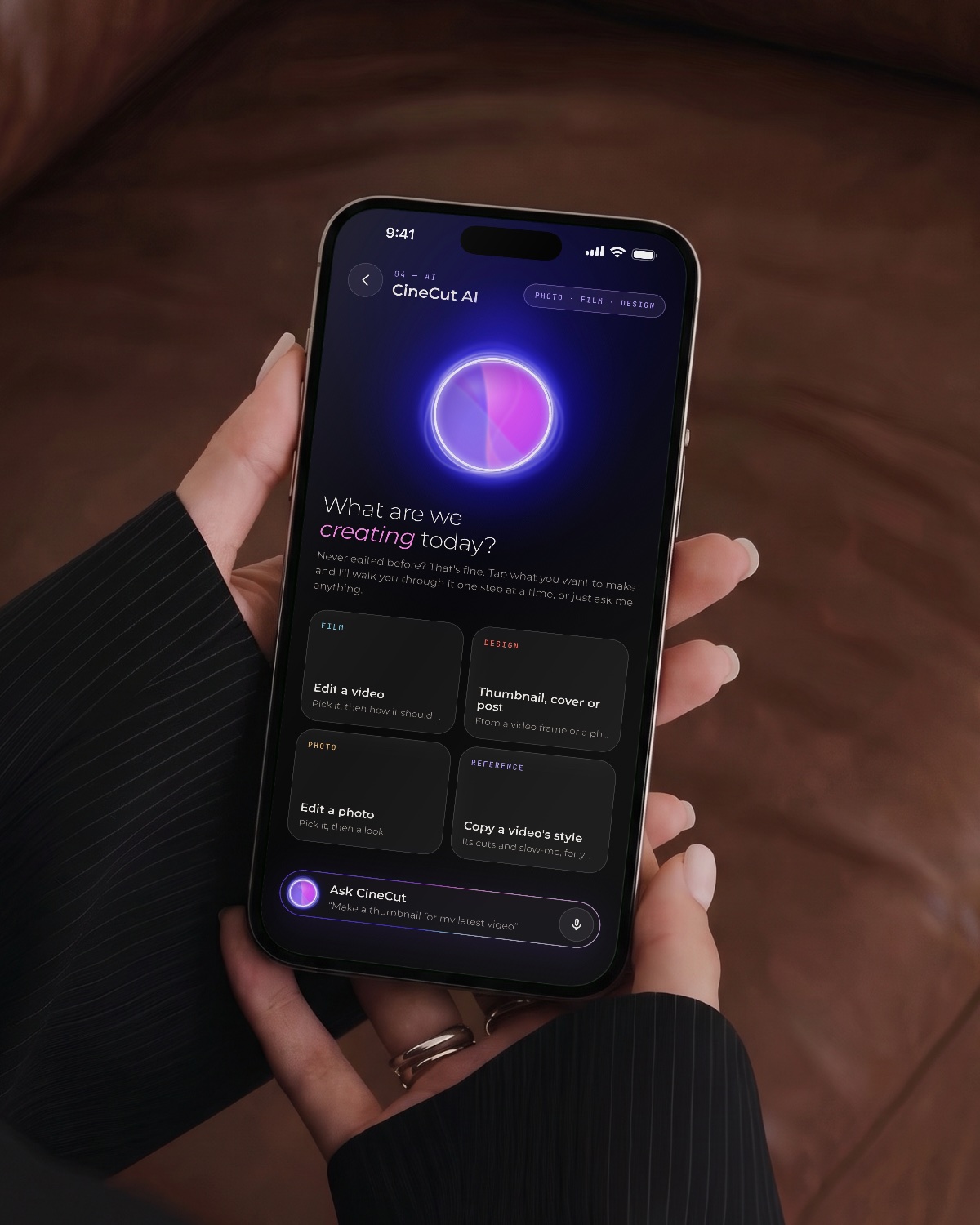 A hand holding an iPhone showing CineCut AI: Edit a video, Thumbnail, Edit a photo, Copy a video's style
