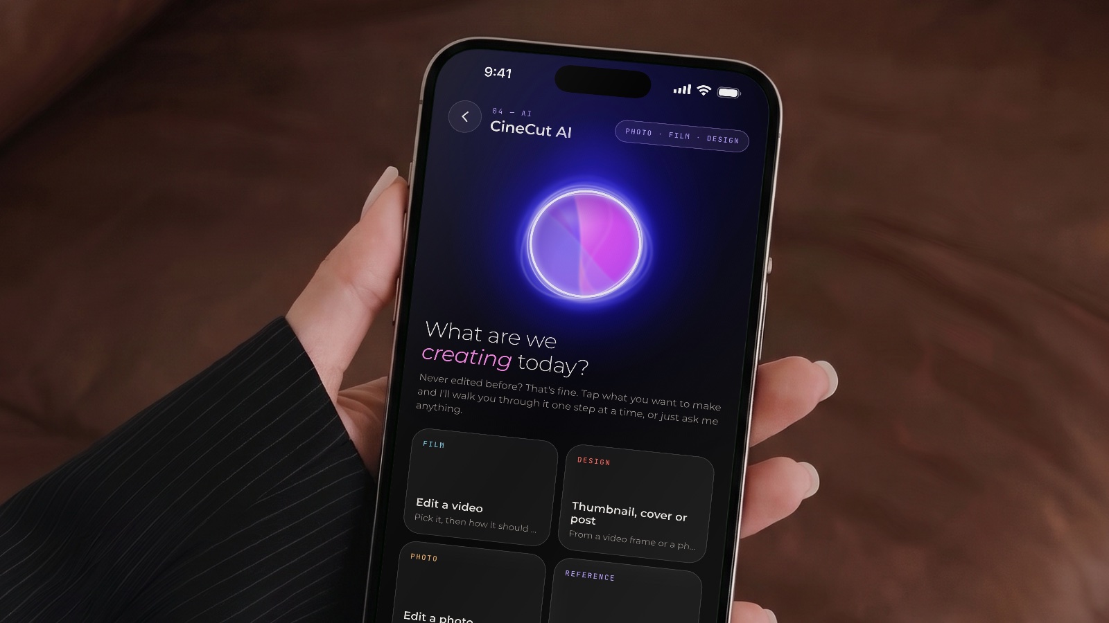 A hand holding an iPhone showing CineCut AI